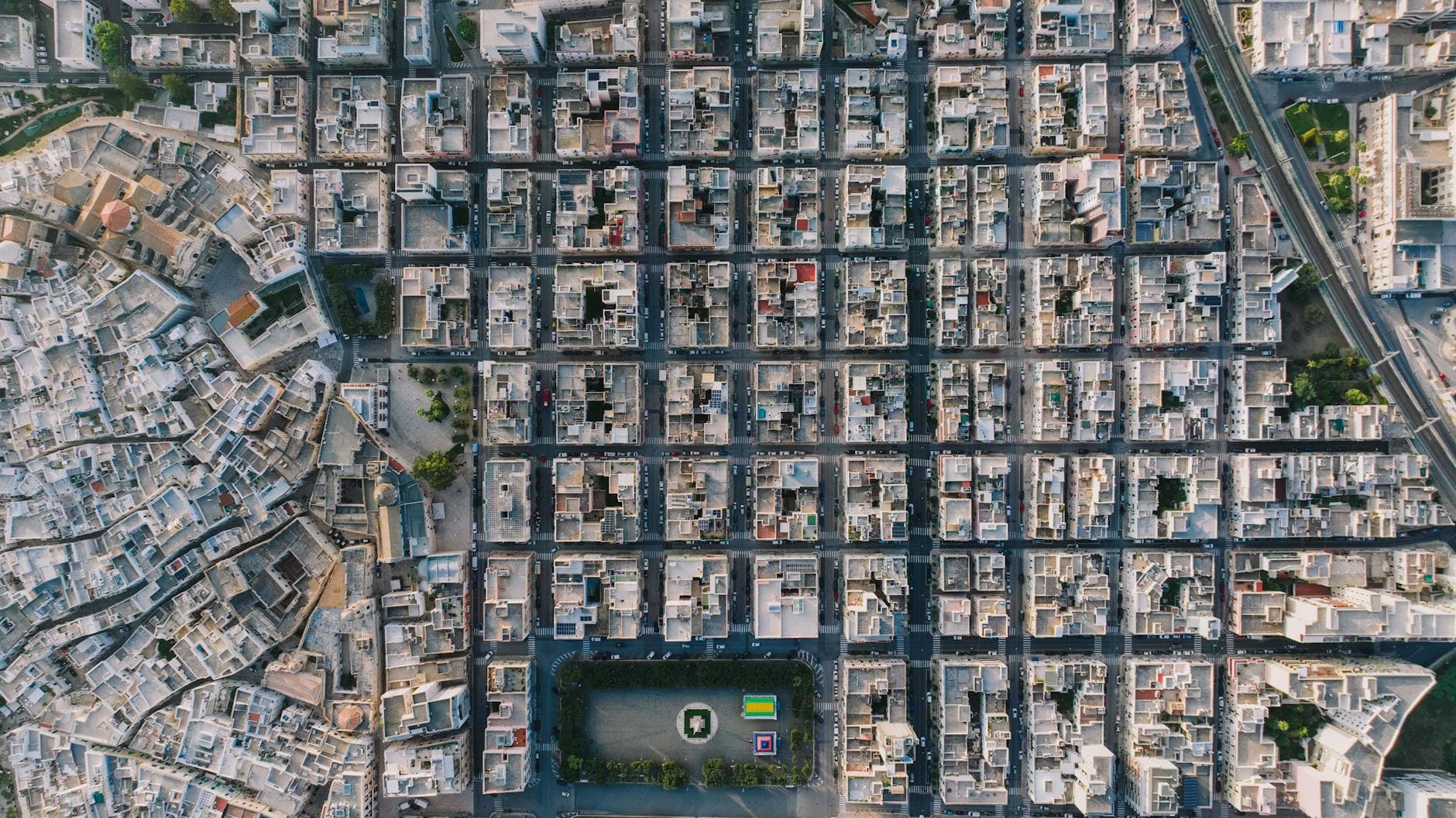 A stunning aerial view of Monopoli, Italy showcasing its grid-like urban layout during the day.