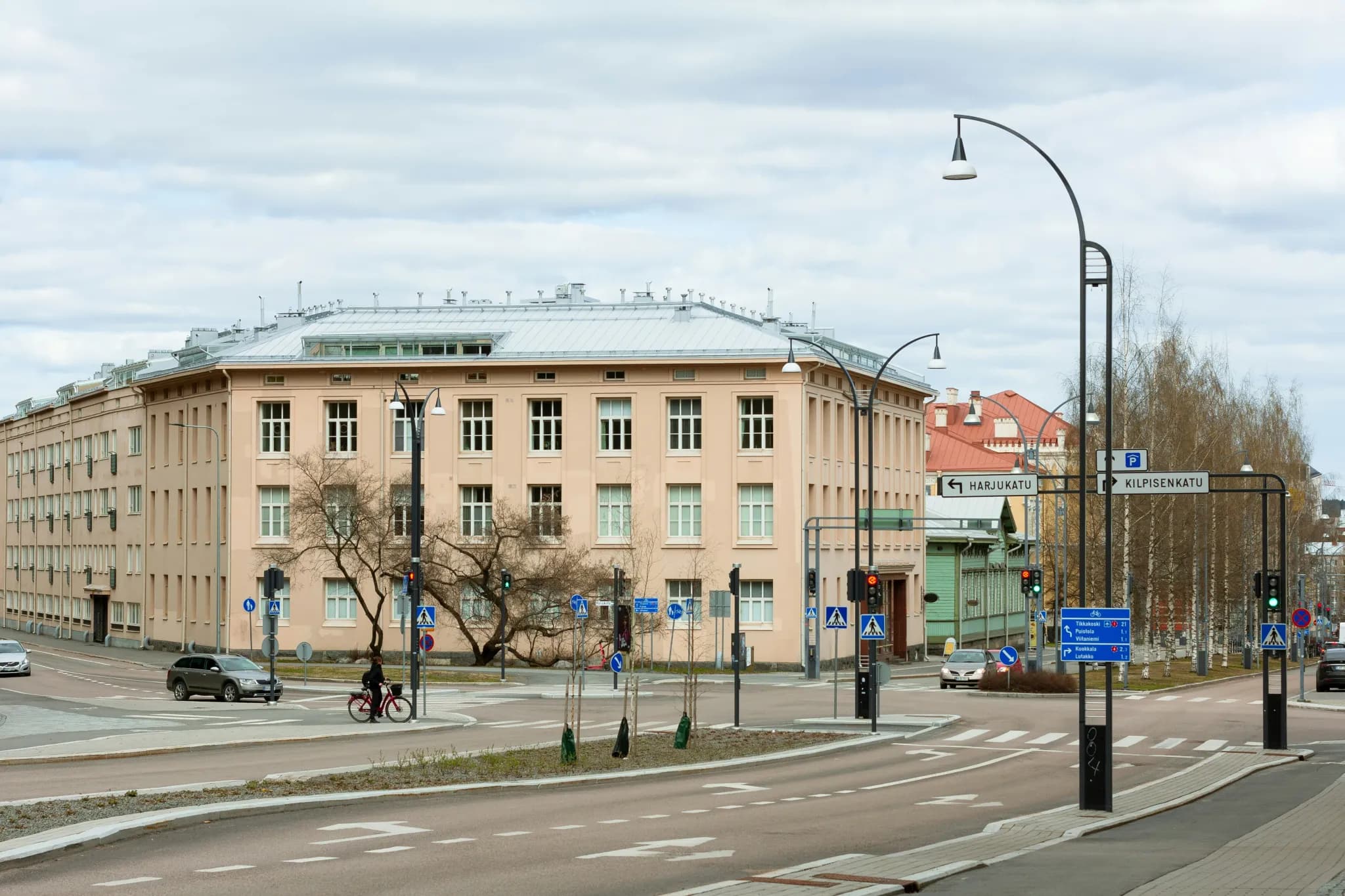 a city street with a large building in the background
