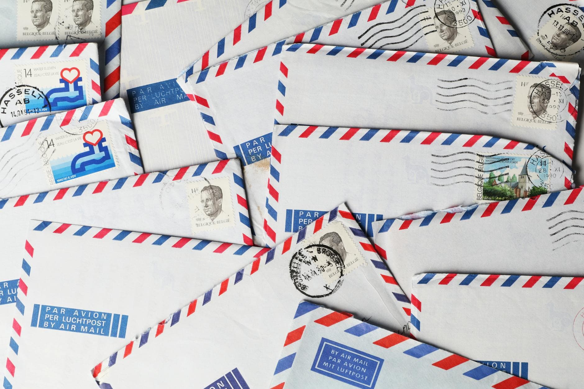 A close-up of vintage airmail envelopes with stamps and postmarks, showcasing nostalgic design.