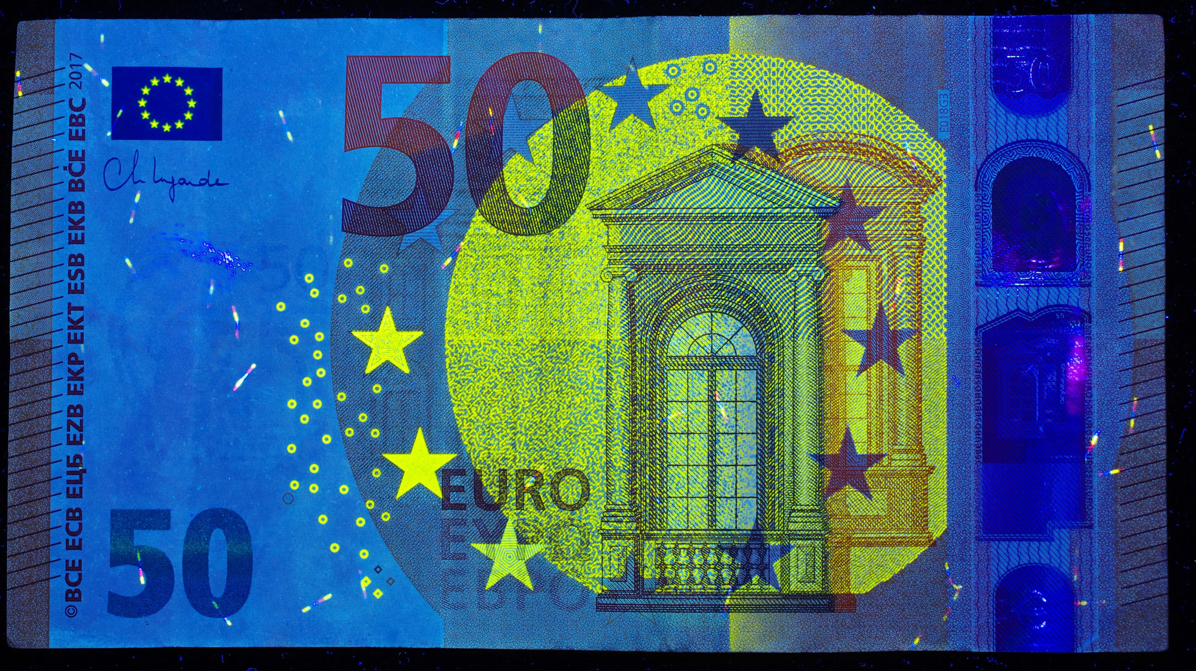 A 50 euro bill with a building and stars on it