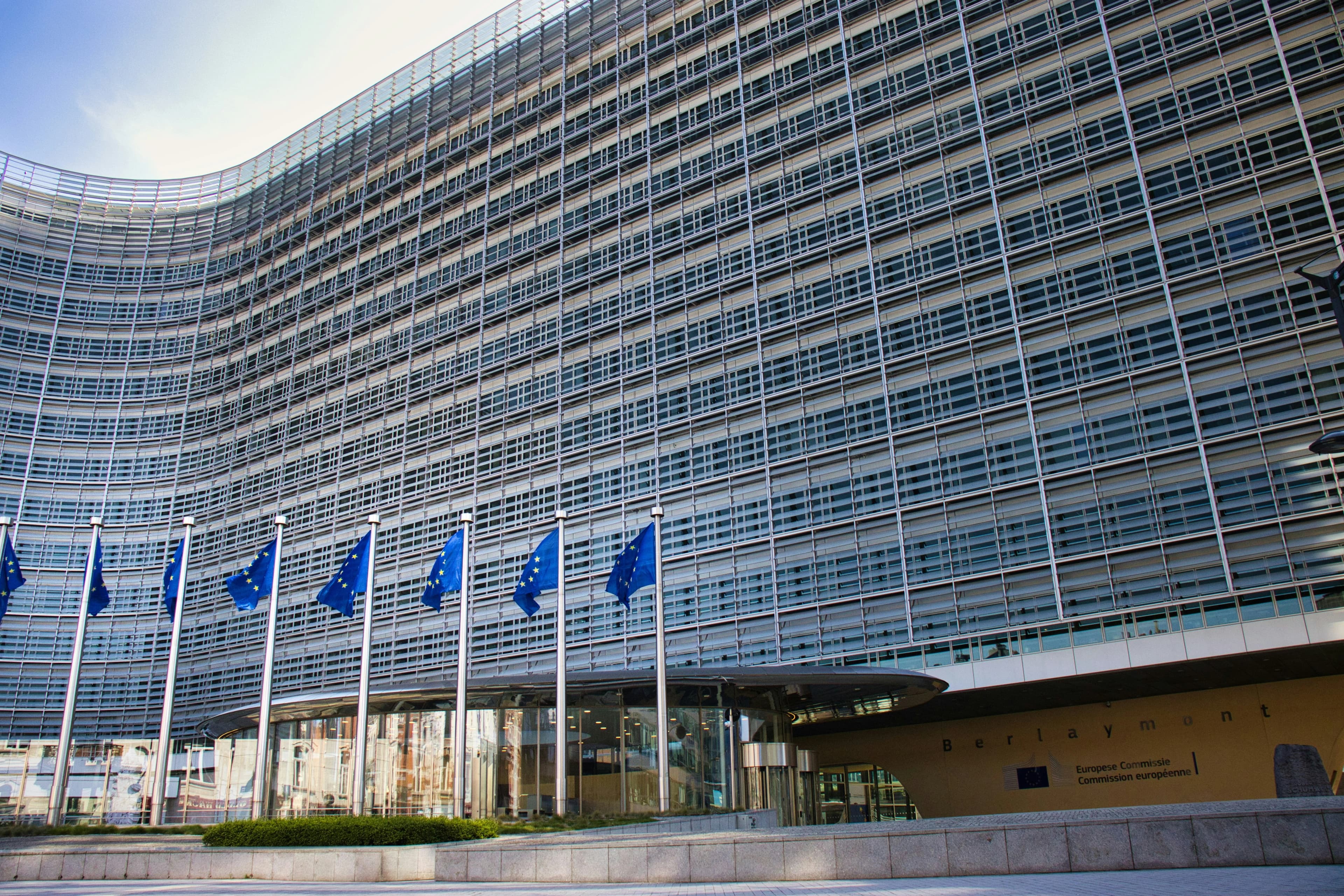 Modern glass building with european union flags