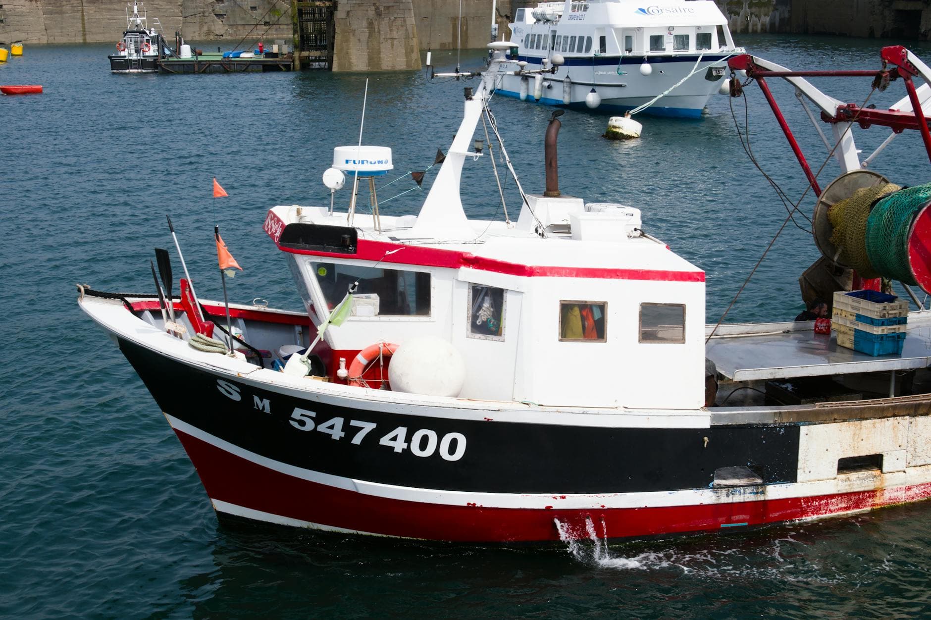 Colorful fishing boat docked in a harbor at Saint-Malo, Brittany, France.