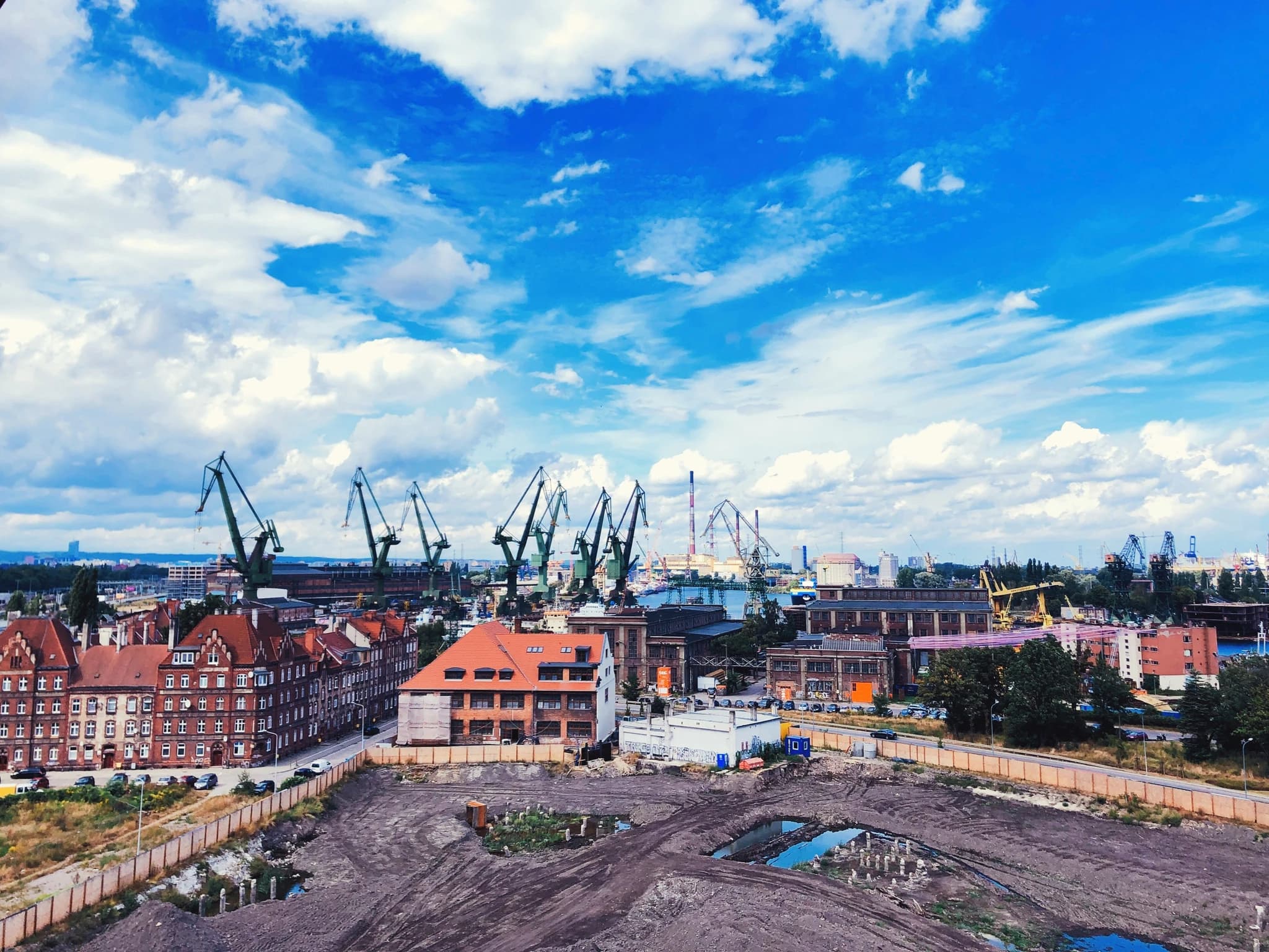 houses and buildings under blue sky and white clouds during daytime