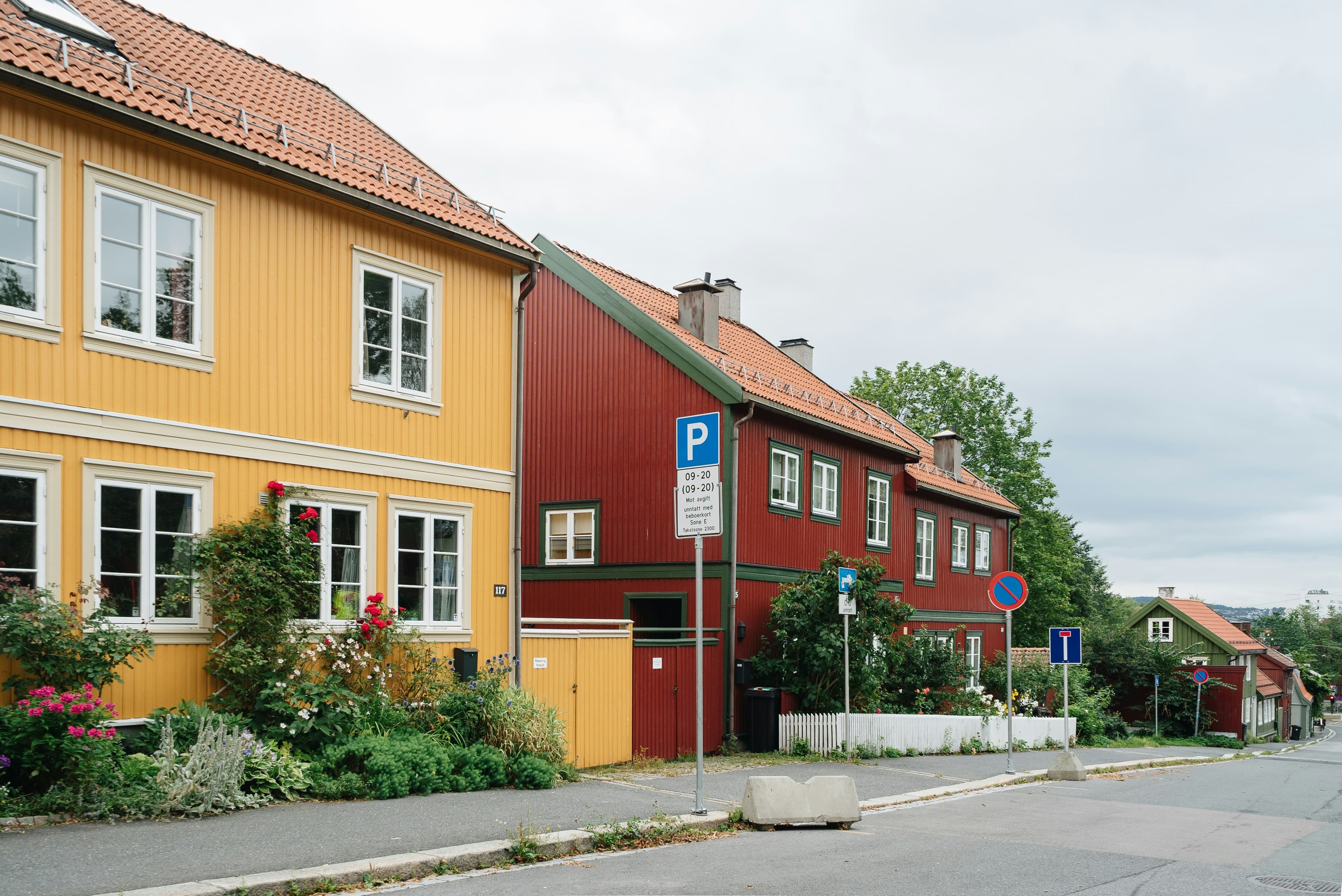 a row of houses with a street sign in front of them