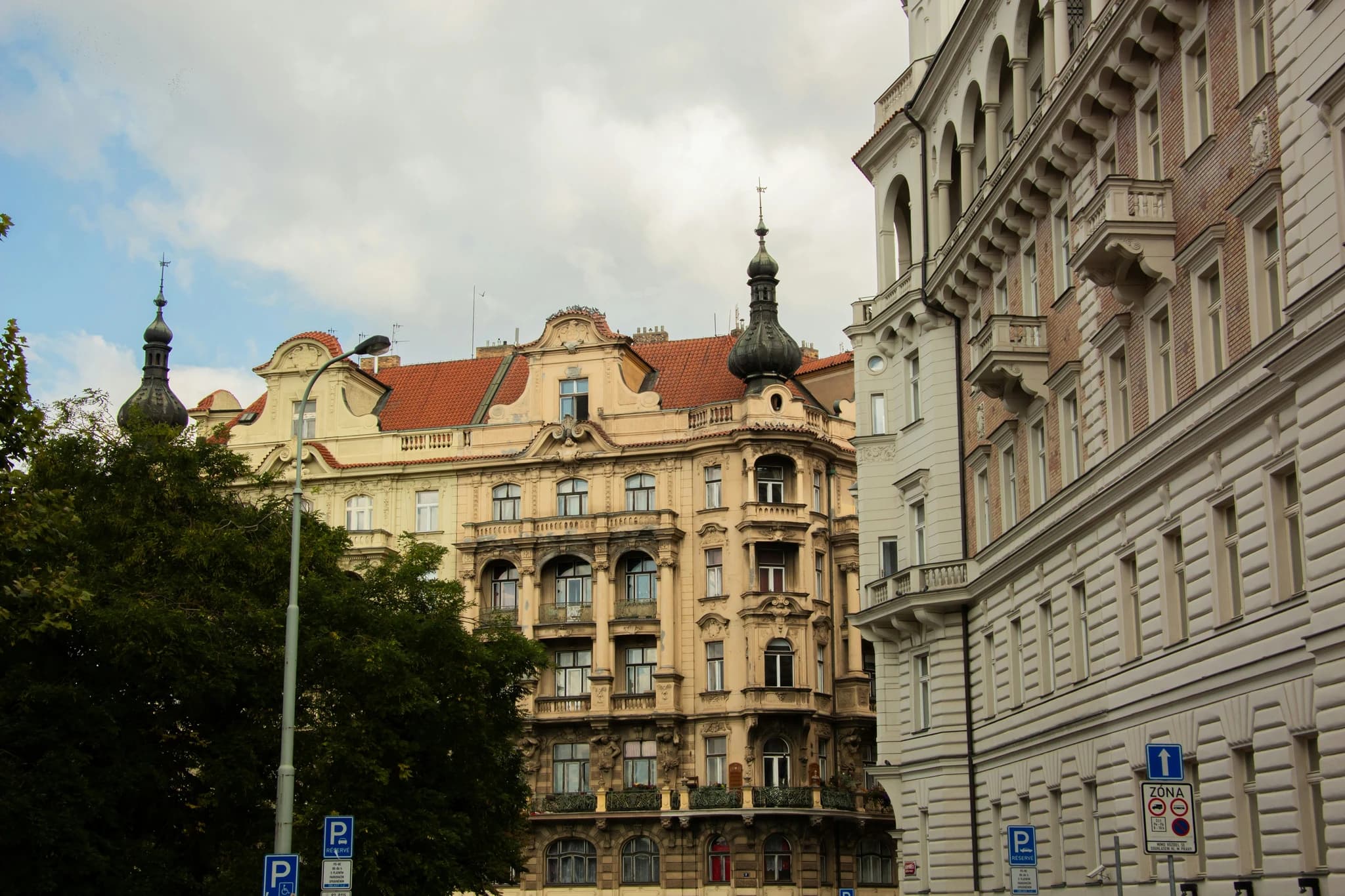 Ornate buildings with spires under cloudy sky